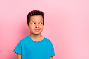 Photo portrait of pretty schoolboy look interested empty space dressed stylish blue outfit isolated on pink color background