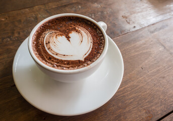 hot chocolate in a white cup on a wooden table