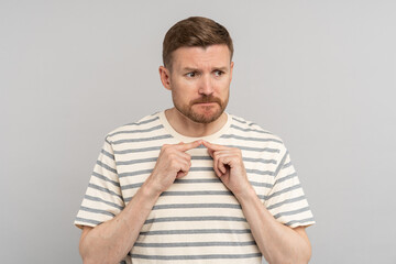 Embarrassed middle aged man senses of shame looking away think about problem. Confused shy...