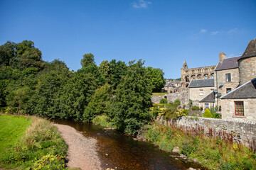 Fototapeta na wymiar View of Jedburgh former royal burgh in the Scottish Borders. Small city on a river Jed Water with its cathedral. Stunning scottish city with idyllic landscapes and views. Historical landmark. 
