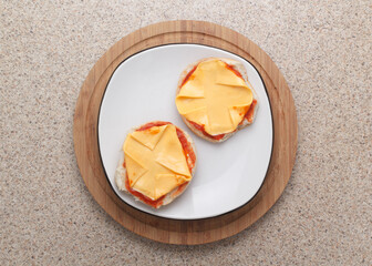 Cheese and pizza sauce sandwiches on kitchen countertop