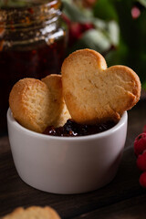 Homemade heart shape cookies in a bowl with jam