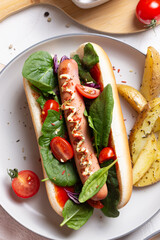 French hot dog with grilled sausage and fried potatoes for dinner