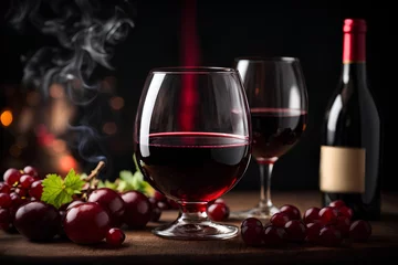 Fotobehang Wine glass of red wine, wine bottle and grapes on black background. Commercial promotional photo  © Logvin art