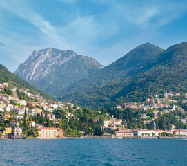 Fototapeta na wymiar Town on Lake Como coast (Italy). Summer view from ship board