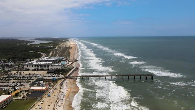 Aerial view of a long pier along the beach in St. Augustine, Florida, United States.