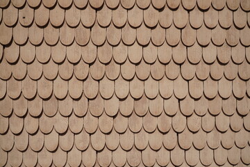 Light wooden tiles of the wall of the house as a pattern 