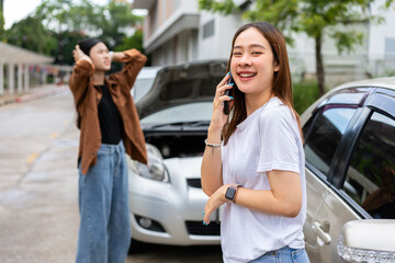 Asian women driver check for damage after a car accident before taking pictures and sending...