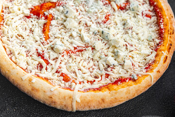 raw pizza four cheeses assorted akmezan cheese, gorgonzola, mozzarella, emmental fast food appetizer meal food snack on the table copy space food background rustic top view