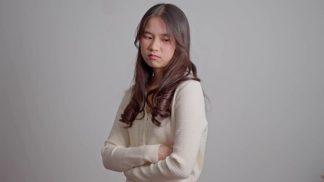 Portrait of Asian angry and sad hipster girl on a white screen background, The emotion of a hipster when tantrum and mad, expression of grumpy emotion. Teenager emotional control concept