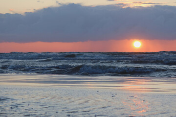 Scenic sunset over the sea. Baltic sea after the rainy day. Poland seaside, Leba village and beach. Seascape
