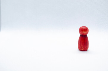 Red wooden figure on white background with customizable space for text. Copy space.