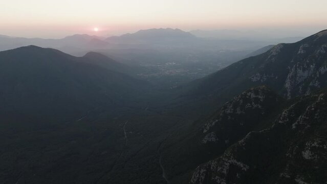 Aerial view of the sun setting down across the valley in Serino along the Mount Terminio with National park, Campania, Avellino, Italy.