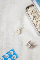 Sewing composition. Beige buttons on beige background.