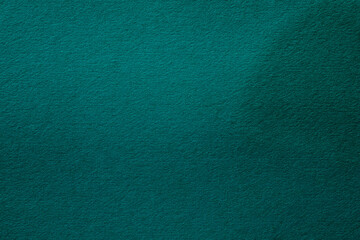 green paper surface with grainy texture