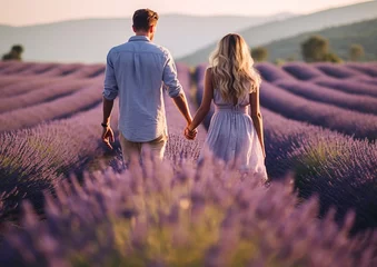 Fototapeten Young romantic couple walking in lavender fields.Macro.AI Generative © DenisMArt