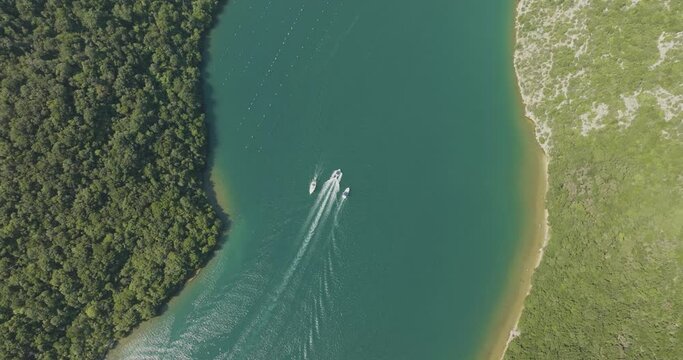 Aerial view of boats sailing along the Limski Fjord (Canal di Leme) in Sveti Lovrec, Istria, Croatia.