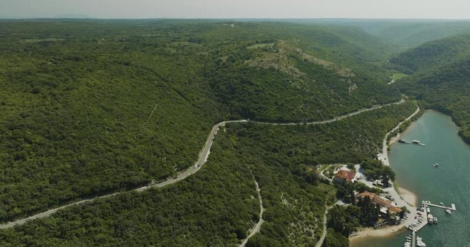 Aerial view of a road on the hills following the Limski Fjord (Canal di Leme) in Sveti Lovrec, Istria, Croatia.