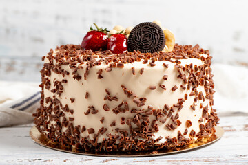 Cake with whipped cream and fruit. Birthday cake on white background
