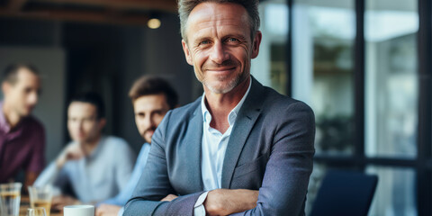 Successful businessman leading a team meeting in a boardroom.