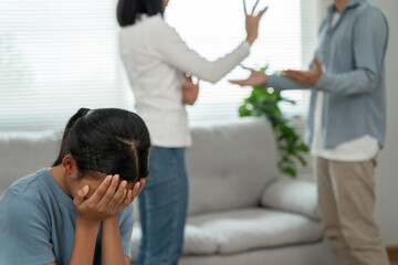 problem in family. daughter use hands cover your face and feel stressed from the parents quarrel. child is have mental problem. quarrels, violence, depression, suicide, discouragement, social problem - obrazy, fototapety, plakaty