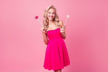 Obraz na płótnie Canvas Photo of adorable cute cheerful person toothy smile arms hold candy stick isolated on pink color background