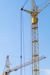 Builders work on large construction sites, and there are many cranes working in the field of new construction.