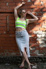 Portrait of a girl near a brick wall