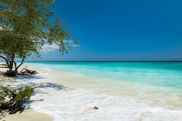Fototapeta na wymiar Tropical sandy beach with turquoise ocean water at Gili Trawangan, one of the Gili islands in Lombok, Indonesia