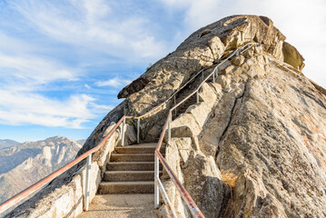 Fototapeta na wymiar Stairway leading up a rocky mountaintop on a sunny autumn day
