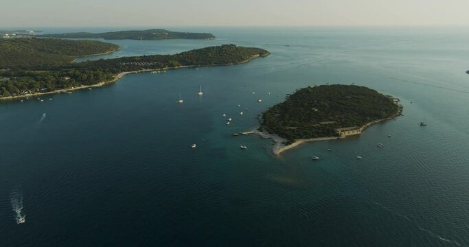Aerial view of sailboat moored along Kotez Island at Brijuni National Park, a group of islands along the Adriatic Sea coastline near Pula, Istria, Croatia.