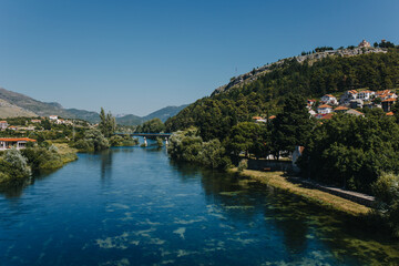 Fototapeta na wymiar Amazing view of Trebinje city and the river in a sunny day. Travel destination in Bosnia and Herzegovina.