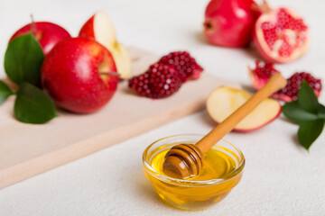 Rosh hashanah, jewish holiday, concept: honey, apple and pomegranate with cutting board, close up
