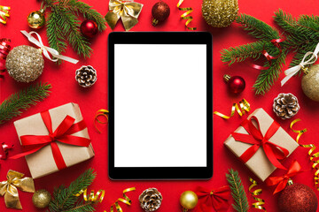 Fototapeta na wymiar Digital tablet mock up with rustic Christmas decorations for app presentation top view with empty space for you design. Christmas online shopping concept. Tablet with copy space on colored background