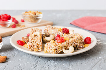 Various granola bars on table background. Cereal granola bars. Superfood breakfast bars with oats, nuts and berries, close up. Superfood concept
