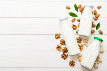Set or collection of various vegan milk almond, cashew, on table background. Vegan plant based milk and ingredients, top view