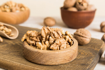 Fresh healthy walnuts in bowl on colored table background. Top view Healthy eating bertholletia concept. Super foods