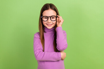 Photo of adorable smart kid with long hairstyle wear purple turtleneck touching eyewear at school...