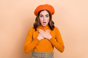 Photo of afraid scared lady wear orange stylish clothes arms pointing showing herself impressed offer isolated on beige color background