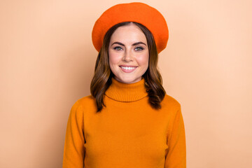 Photo of adorable satisfied lady beaming smile wear fall cozy bright outfit clothes like new purchases isolated on beige color background