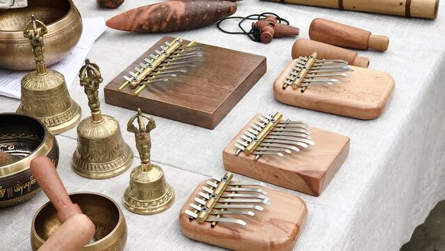 shop handmade musical instruments kalimba bell pipe flute tambourine lying on the counter ,festival of musical instruments artisans