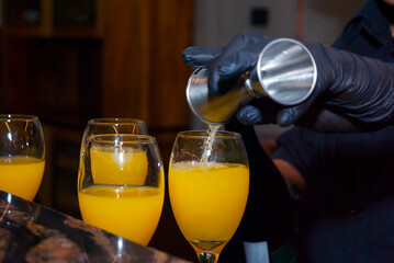 Alcoholic drink made with orange juice and champagne called Mimosa, a space for celebration and joy. - 644532323