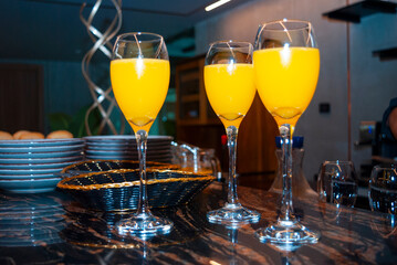 Alcoholic drink made with orange juice and champagne called Mimosa, a space for celebration and joy. - 644532339