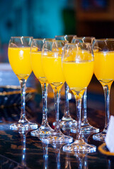Alcoholic drink made with orange juice and champagne called Mimosa, a space for celebration and joy. - 644532534