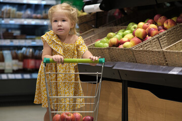 Observe a 2-year-old girl in a supermarket, demonstrating cognitive and motor skills as she independently selects products. A real-world Montessori approach to child development