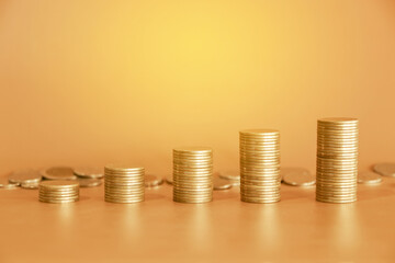 Up stack of golden money coin on yellow background. Business and financial background concept.