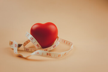 Red heart surrounded by a tape measure. Healthy concept.