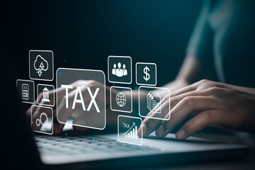 Businessman using computer to fill out income tax refund form Enter the online tax form to pay taxes. state tax government Data analysis, documents, financial research, reports, tax return calculation