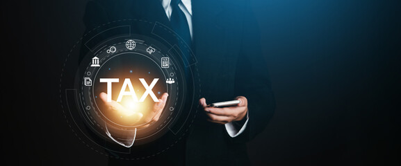 Business hands click virtual technology screen to complete online tax return for tax payments by companies such as Value Added Tax, Income Tax and Property Tax.