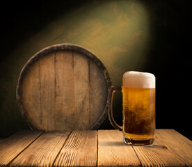 mug of beer, wheat ears, green hops and beer barrel on a wooden background. High quality photo
